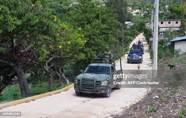 Mexican army members patrol the Ahuhuiyuco community in Chilapa de Alvarez, Guerrero state, Mexico, on June 20, 2017. Some 800 families have fled...