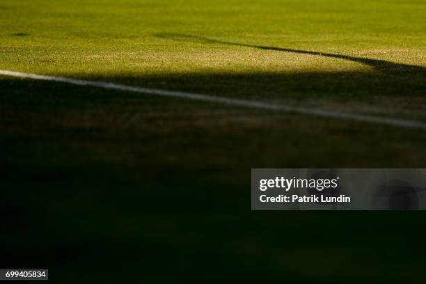 Shadow lenghten as Denis Shapovalov of Canada serves during the 2nd round match against Tomas Berdych of the Czech Republic on day three at Queens...