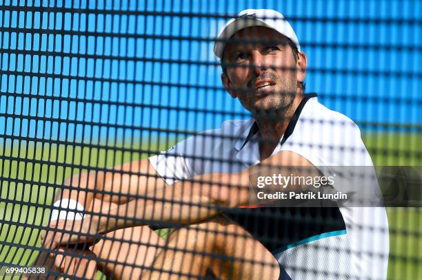 Gilles Muller of Luxemburg disputes a call during the 2nd round match against Jo-Wilfried Tsonga of France on day three at Queens Club on June 21,...