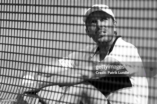 Gilles Muller of Luxemburg disputes a call during the 2nd round match against Jo-Wilfried Tsonga of France on day three at Queens Club on June 21,...