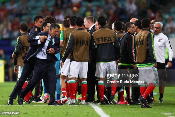 Juan Carlos Osorio, head coach of Mexico is restrained during the FIFA Confederations Cup Russia 2017 Group A match between Mexico and New Zealand at...