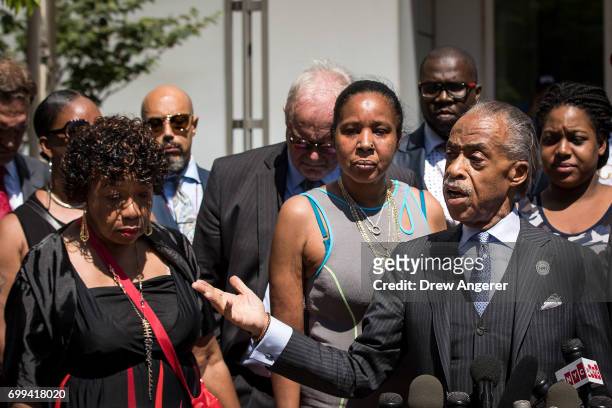 Gwen Carr, mother of the late Eric Garner, and widow Esaw Garner listen as Rev. Al Sharpton speaks to the press after meeting with Department of...