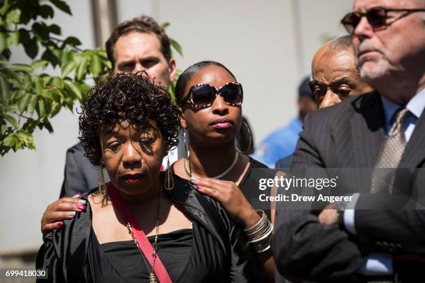 Gwen Carr, mother of the late Eric Garner, is consoled by Ellisha Garner during a press conference after meeting with Department of Justice...