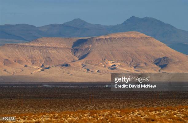 Early morning light shines on the proposed nuclear waste dump site of Yucca Mountain February 7, 2002 at Nellis Air Force Base located approximately...