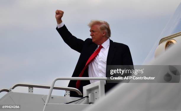 President Donald Trump gestures before boarding Air Force One at Joint Andrews Airforce base, Maryland on June 21, 2017 in Washington, DC. / AFP...