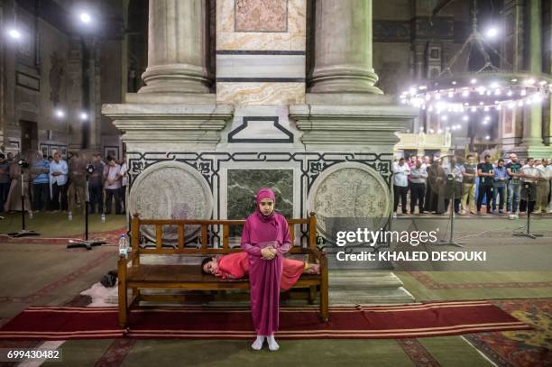 An Egyptian Muslim girl performs Tarawih prayers on the occasion of Laylat al-Qadr which falls on the 27th day of the fasting month of Ramadan, at...