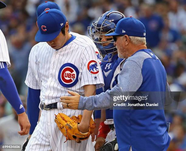 Manager Joe Maddon 0f the Chicago Cubs goes to the mound to talk with Koji Uehara in the 8th inning against the San Diego Padres at Wrigley Field on...