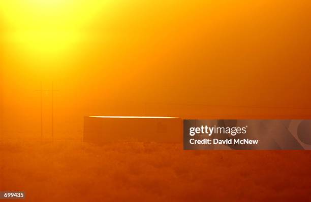 Truck travels along Highway 95 during sunset February 7, 2002 near the tiny community of Amargosa Valley, which is the gateway to the proposed...