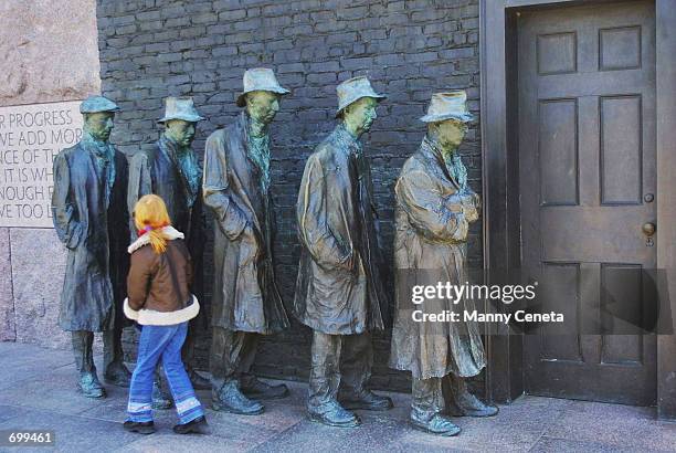 Georgie Cox touches George Segals sculpture of a 1930s bread line which captures the hunger and desperation that many Americans felt during the...
