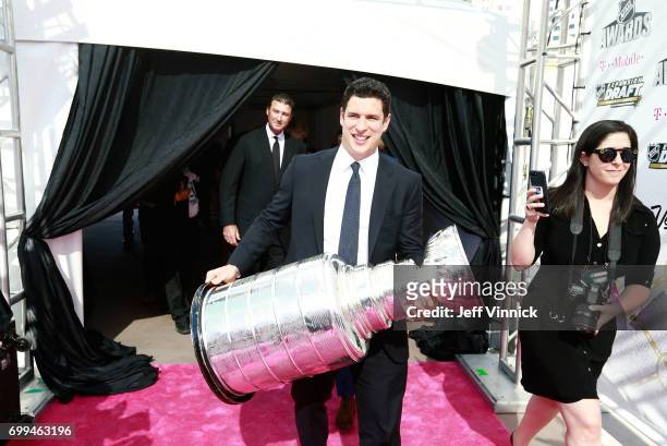 Sidney Crosby of the Pittsburgh Penguins arrives with the Stanley Cup on the magenta carpet for the 2017 NHL Awards at T-Mobile Arena on June 21,...