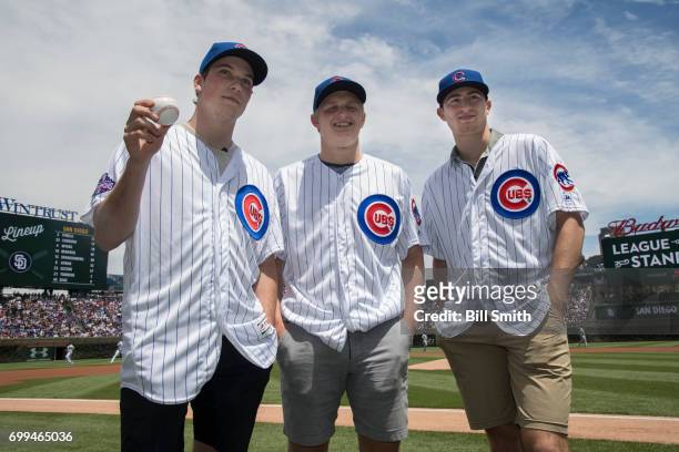 Nolan Patrick, Casey Mittelstadt and Gabriel Vilardi pose for photographers before a game between the Chicago Cubs and the San Diego Padres during...