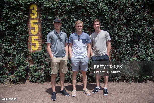 Gabriel Vilardi, Casey Mittelstadt and Nolan Patrick stand in the outfield before the game between the Chicago Cubs and the San Diego Padres during...