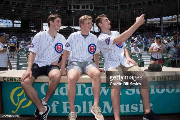 Nolan Patrick, Casey Mittelstadt and Gabriel Vilardi take a selfie on the field before the game between the Chicago Cubs and the San Diego Padres...