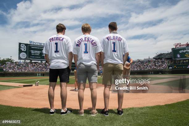 Nolan Patrick, Casey Mittelstadt and Gabriel Vilardi stand on the field before the game between the Chicago Cubs and the San Diego Padres during the...