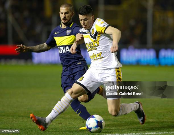 Dario Benedetto of Boca Juniors fights for the ball with Carlos Rodriguez of Olimpo during a match between Olimpo and Boca Juniors as part of Torneo...