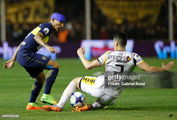 Ricardo Centurion of Boca Juniors fights for the ball with Carlos Rodriguez of Olimpo during a match between Olimpo and Boca Juniors as part of...