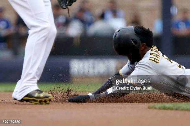 Josh Harrison of the Pittsburgh Pirates steals second base past Orlando Arcia of the Milwaukee Brewers in the first inning at Miller Park on June 21,...