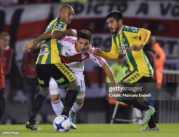 Sebastian Driussi of River Plate fights for ball with Roberto Brum Gutierrez and Alan Alegre of Aldosivi during a match between River Plate and...