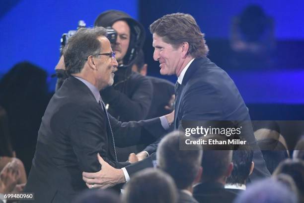 Head coach John Tortorella of the Columbus Blue Jackets shakes hands with head coach Mike Babcock of the Toronto Maple Leafs after Tortorella wins...