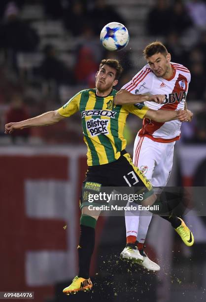 Lucas Alario of River Plate goes for a header with Ramiro Arias of Aldosivi during a match between River Plate and Aldosivi as part of Torneo Primera...