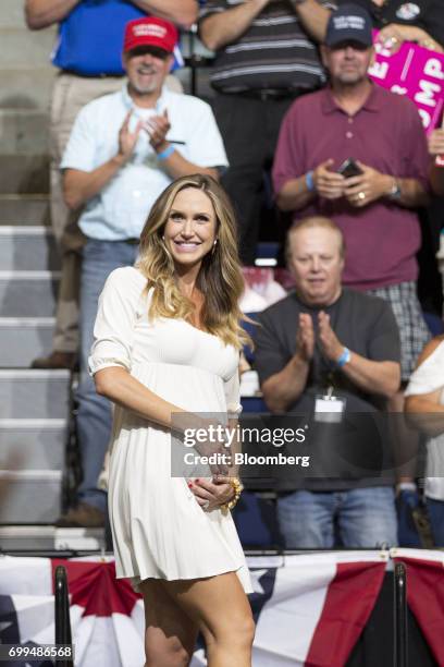 Lara Trump, daughter-in-law of President Donald Trump, rubs her stomach, she's pregnant with her first child, as she arrives to introduce Trump...