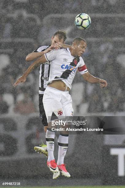 Joel Carliof Botafogo battles for the ball with Luis Fabiano of Vasco during the match between Botafogo and Vasco as part of Brasileirao Series A...