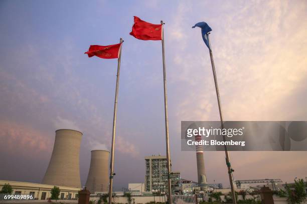 Chinese national flag, center, flies atop a flagpole at the Sahiwal coal power plant, owned by China's state-owned Huaneng Shandong Rui Group, in...