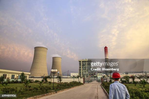 Chinese worker walks along a path at the Sahiwal coal power plant, owned by China's state-owned Huaneng Shandong Rui Group, in Sahiwal, Punjab,...