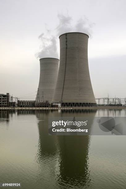 Vapor rises from cooling towers at the Sahiwal coal power plant, owned by China's state-owned Huaneng Shandong Rui Group, in Sahiwal, Punjab,...