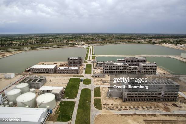 Buildings stand under construction at the Sahiwal coal power plant, owned by China's state-owned Huaneng Shandong Rui Group, in Sahiwal, Punjab,...