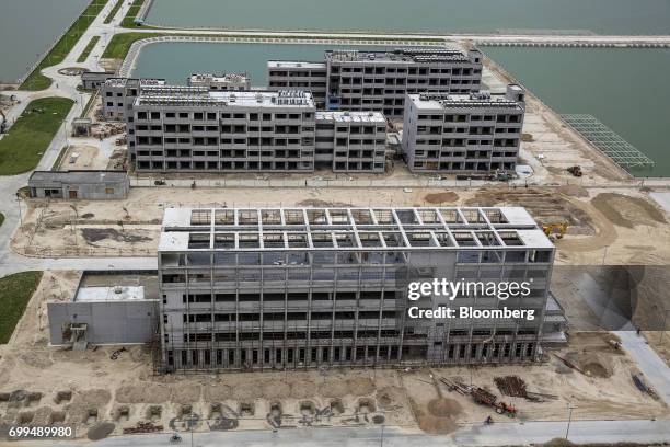 Buildings stand under construction at the Sahiwal coal power plant, owned by China's state-owned Huaneng Shandong Rui Group, in Sahiwal, Punjab,...