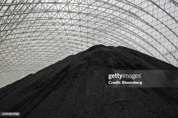 Pile of coal sits at the Sahiwal coal power plant, owned by China's state-owned Huaneng Shandong Rui Group, at sunset in Sahiwal, Punjab, Pakistan,...