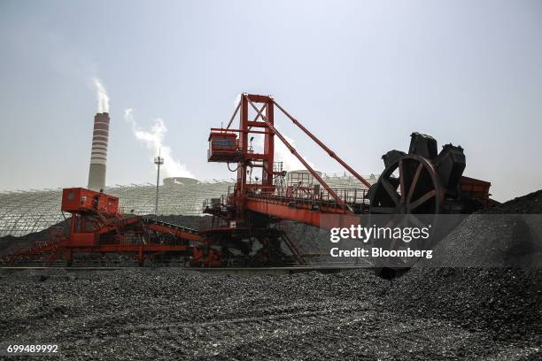 Coal dredger transfers coal from a storage area onto a conveyor at the Sahiwal coal power plant, owned by China's state-owned Huaneng Shandong Rui...
