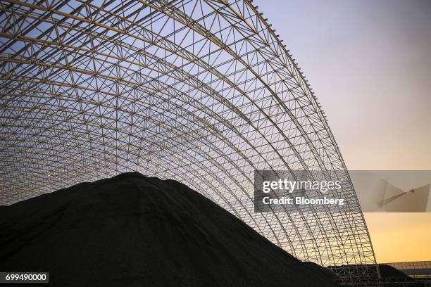 Pile of coal sits at the Sahiwal coal power plant, owned by China's state-owned Huaneng Shandong Rui Group, at sunset in Sahiwal, Punjab, Pakistan,...