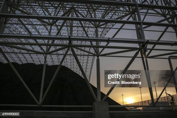 Pile of coal sits at the Sahiwal coal power plant, owned by China's state-owned Huaneng Shandong Rui Group, at sunset in Sahiwal, Punjab, Pakistan,...