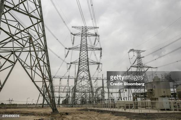 Power lines hang from transmission pylons at the Sahiwal coal power plant, owned by China's state-owned Huaneng Shandong Rui Group, in Sahiwal,...