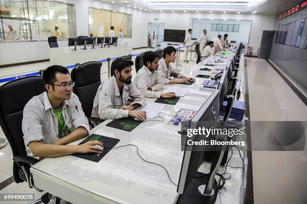 Chinese and Pakistani engineers work in a control room at the Sahiwal coal power plant, owned by China's state-owned Huaneng Shandong Rui Group, in...