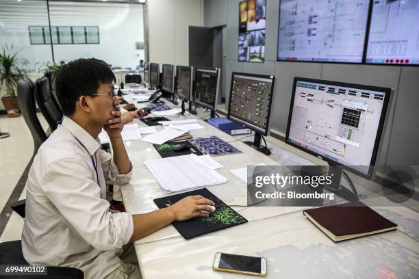 Chinese engineer works in a control room at the Sahiwal coal power plant, owned by China's state-owned Huaneng Shandong Rui Group, in Sahiwal,...