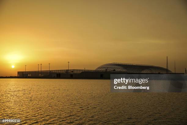 Coal storage area stands at the Sahiwal coal power plant, owned by China's state-owned Huaneng Shandong Rui Group, at sunset in Sahiwal, Punjab,...