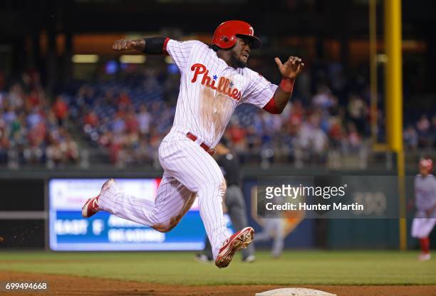 Odubel Herrera of the Philadelphia Phillies rounds third base and heads home in the ninth inning during a game against the St. Louis Cardinals at...