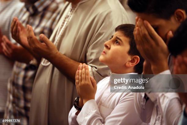 Muslims attend a mass prayer at the Al-Dubbaha Mosque, to mark Laylat al-Qadr, holiest of the Muslims' five holy nights during the Muslims' holiest...