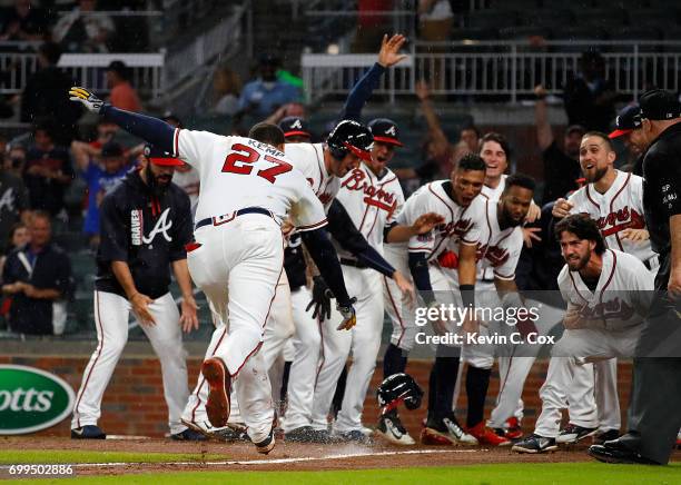 Matt Kemp of the Atlanta Braves celebrates after hitting a walk-off two-run homer in the 11th inning for a 5-3 win over the San Francisco Giants at...