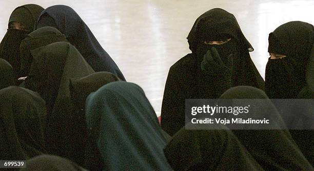 Female supporters of Jafar Umar Thalib, Afghan war veteran and commander of Indonesias militant Laskar Jihad, listen to him preach at a mosque...