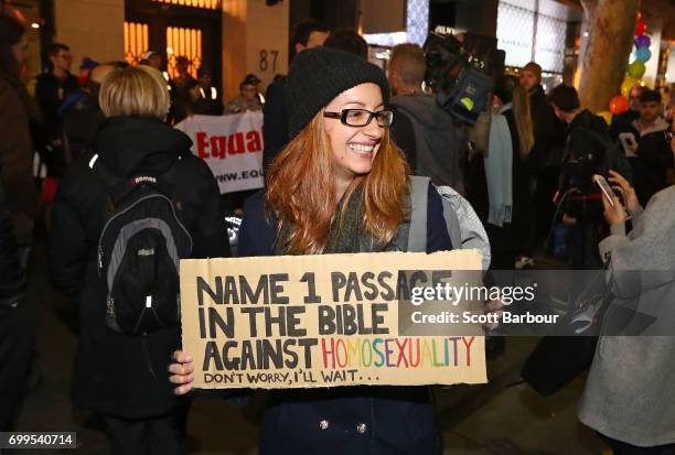 Protesters hold aloft placards outside of the Athenaeum club, where former Australian tennis player and Christian pastor Margaret Court is the...