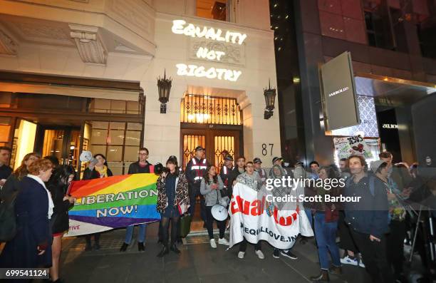 Protesters hold aloft placards outside of the Athenaeum club, where former Australian tennis player and Christian pastor Margaret Court is the...