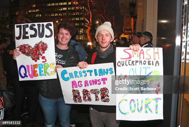 Protesters hold aloft placards outside of the Athenaeum club, where former Australian tennis player and Christian pastor Margaret Court is the...