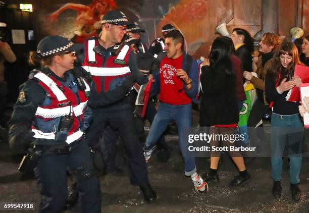 Police officers attempt to stop protesters from storming the back entrance to the Athenaeum club, where former Australian tennis player and Christian...