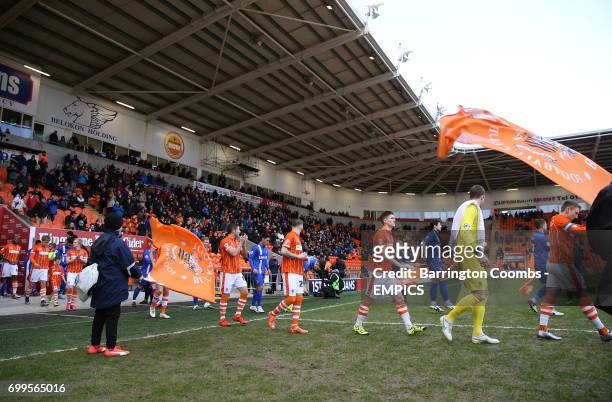 Blackpool and Gillingham players make their way out on to the pitch prior to kick-off.