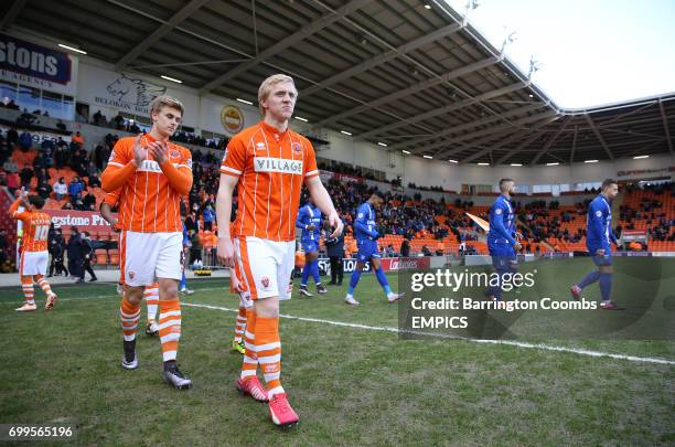 Blackpool's Mark Cullen and Brad Potts make their way out on to the pitch prior to kick-off.