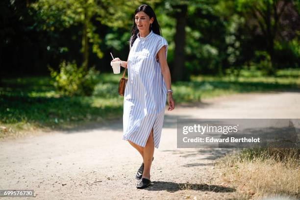 Guest wears a striped dress, outside the Balenciaga show, during Paris Fashion Week - Menswear Spring/Summer 2018, on June 21, 2017 in Paris, France.